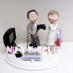Bonequinhos do bolo de casamento com noiva tirando video game do noivo