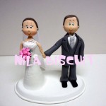 Bonequinhos do bolo de casamento com noivinhos unidos