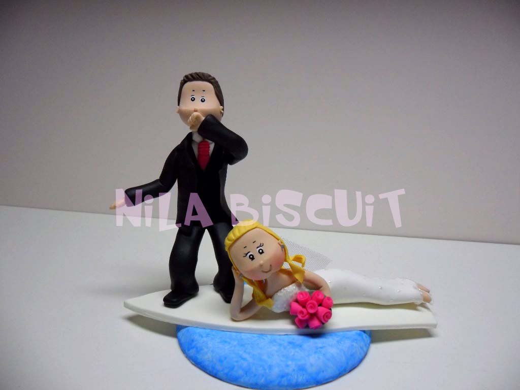 Bonecos do bolo de casamento com noivo surfando